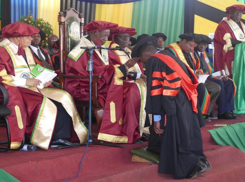 In this picture, Chancellor of Sokoine University of Agriculture (SUA) Hon. Joseph Sinde Warioba (Right) conferring PhD awards to one of graduate during 34th SUA graduation Ceremony which was held on 23rd November 2018 at Nelson Mandela Freedom Square in Solomon Mahlangu Campus located in Mazimbu, Morogoro